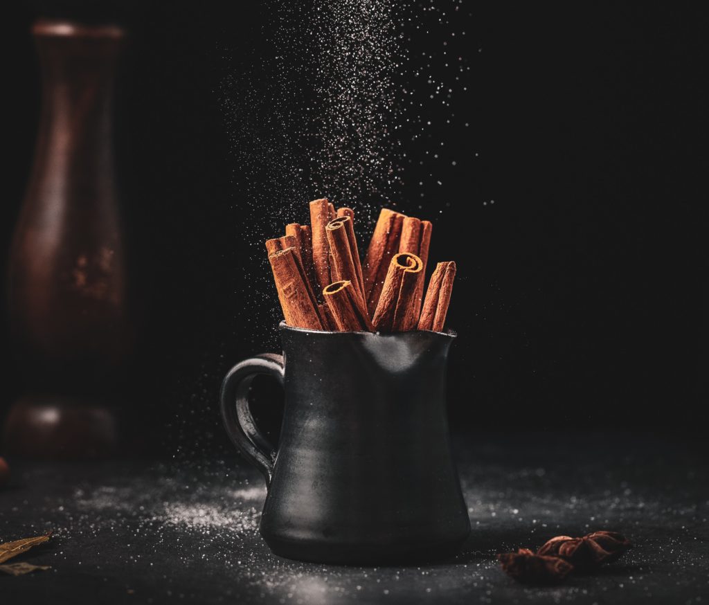 A mug full of cinnamon sticks meant to convey the cassia flavor in Rou Gui oolong tea